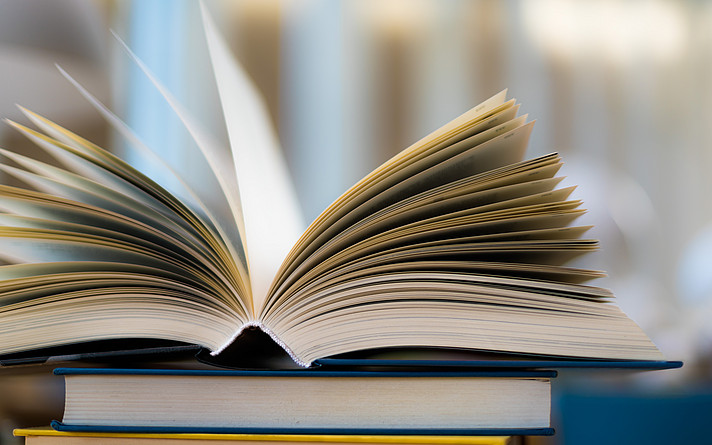 Open book lying on the table in the library